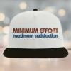 a white hat with minimum effort maximum satisfaction stitching in orange by the asocial chameleon
